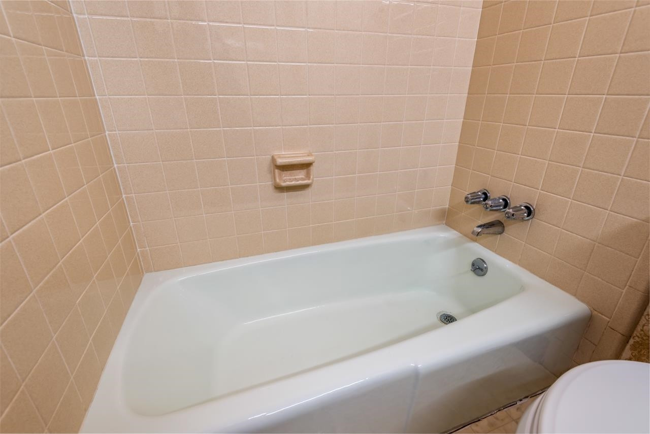 7222 Russell Road Durham, NC 27712 - Photo 13 of 38 a bathroom with a bathtub
