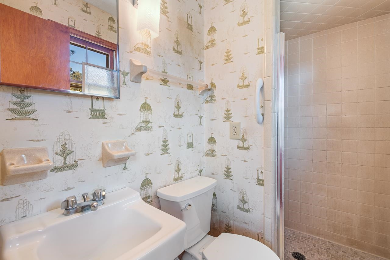 7222 Russell Road Durham, NC 27712 - Photo 16 of 38 a bathroom with a sink a toilet and shower curtain