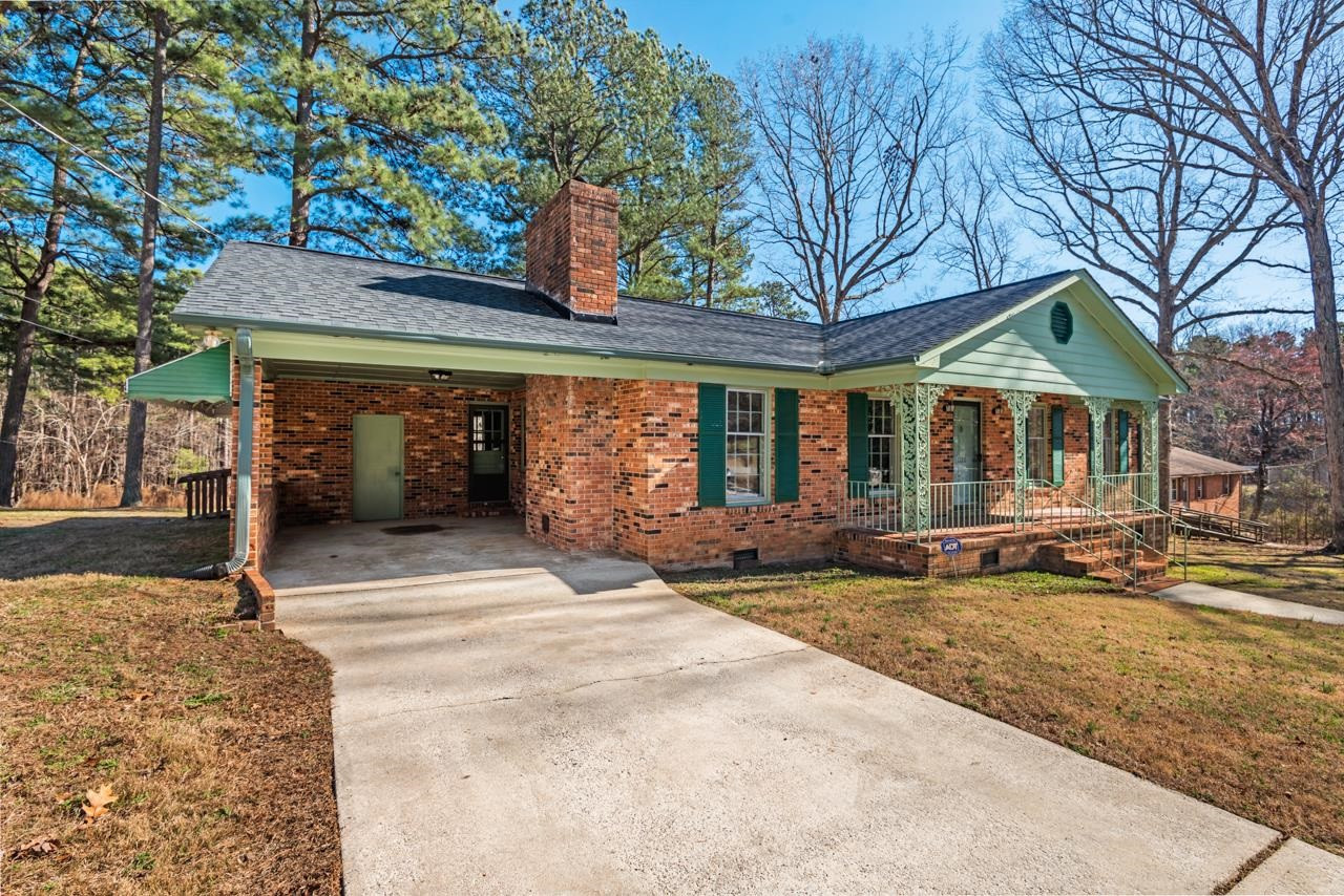 7222 Russell Road Durham, NC 27712 - Photo 3 of 38 a front view of a house with garden and patio