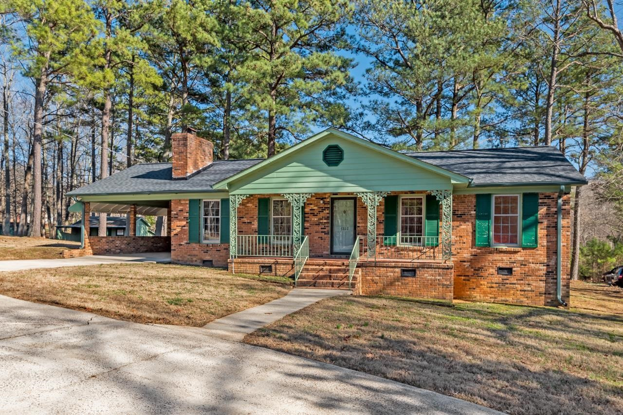 7222 Russell Road Durham, NC 27712 - Photo 36 of 38 a front view of a house with garden