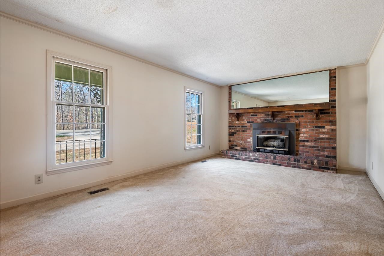 7222 Russell Road Durham, NC 27712 - Photo 5 of 38 an empty room with furniture and a window