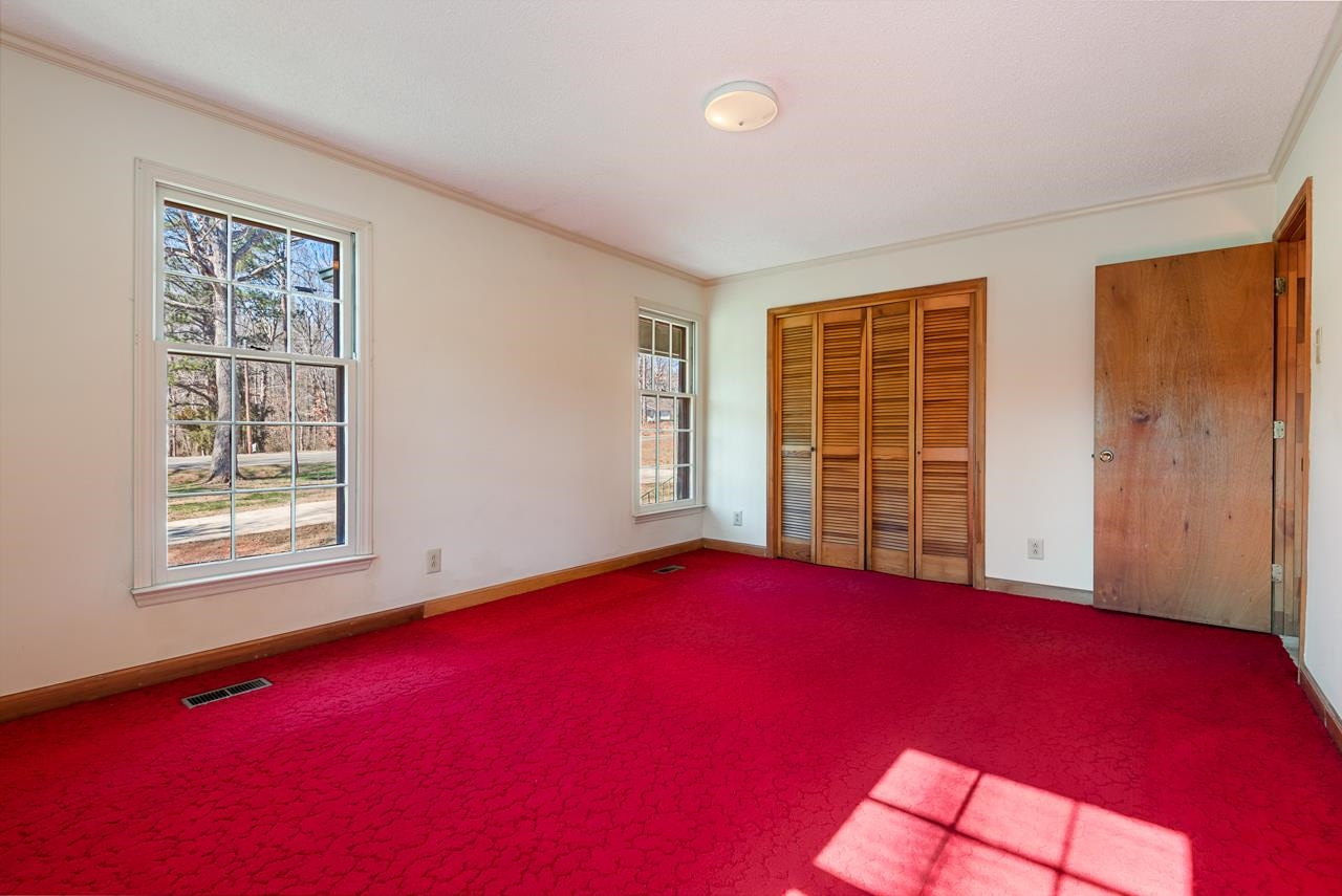 7222 Russell Road Durham, NC 27712 - Photo 10 of 38 a view of empty room with windows