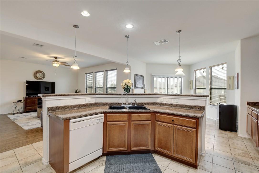 356 Matthews Kyle, TX 78640 - Photo 29 of 30 An inviting open-concept kitchen features a peninsula with counter seating and a view of the adjacent living area.