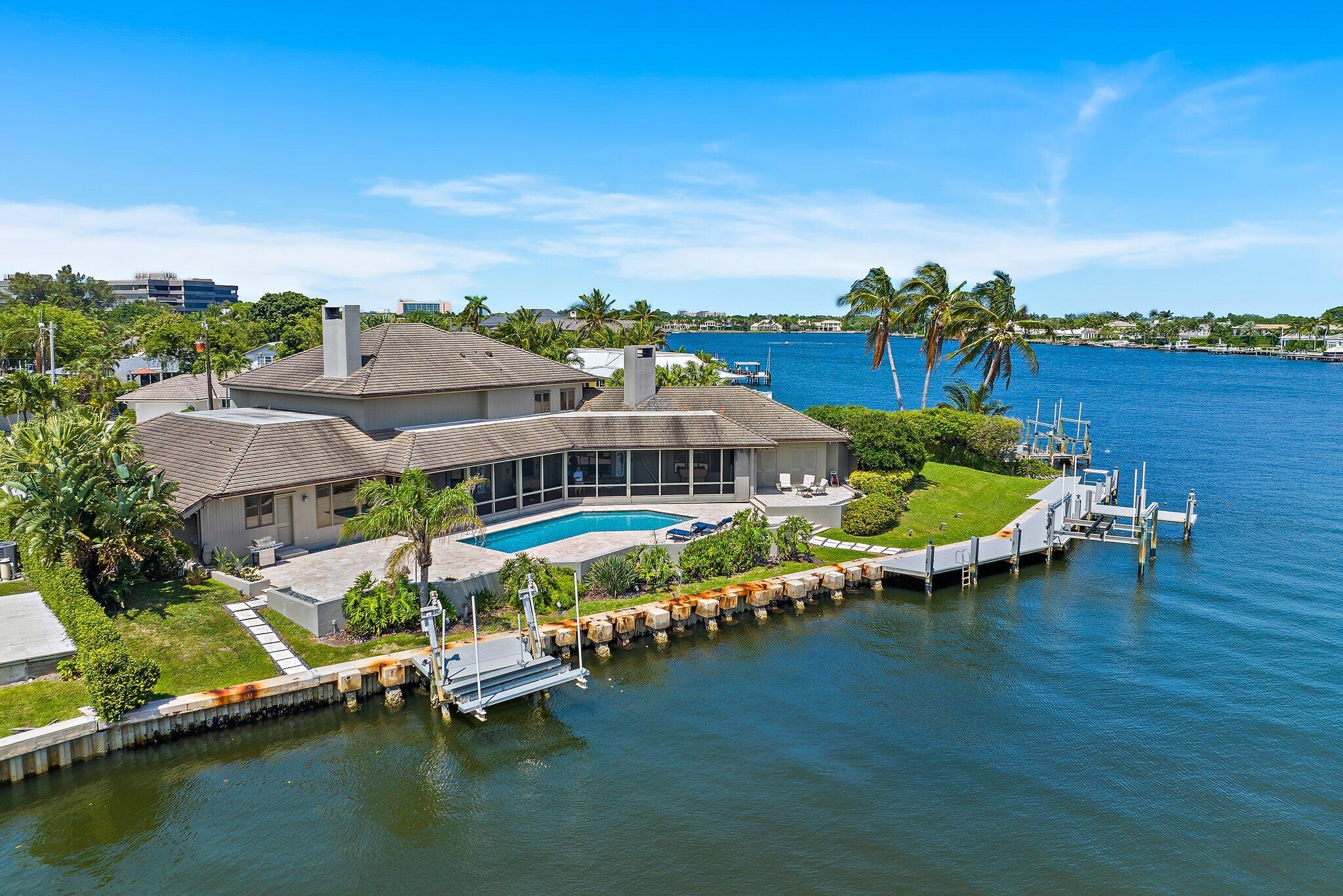 an aerial view of a swimming pool with outdoor seating