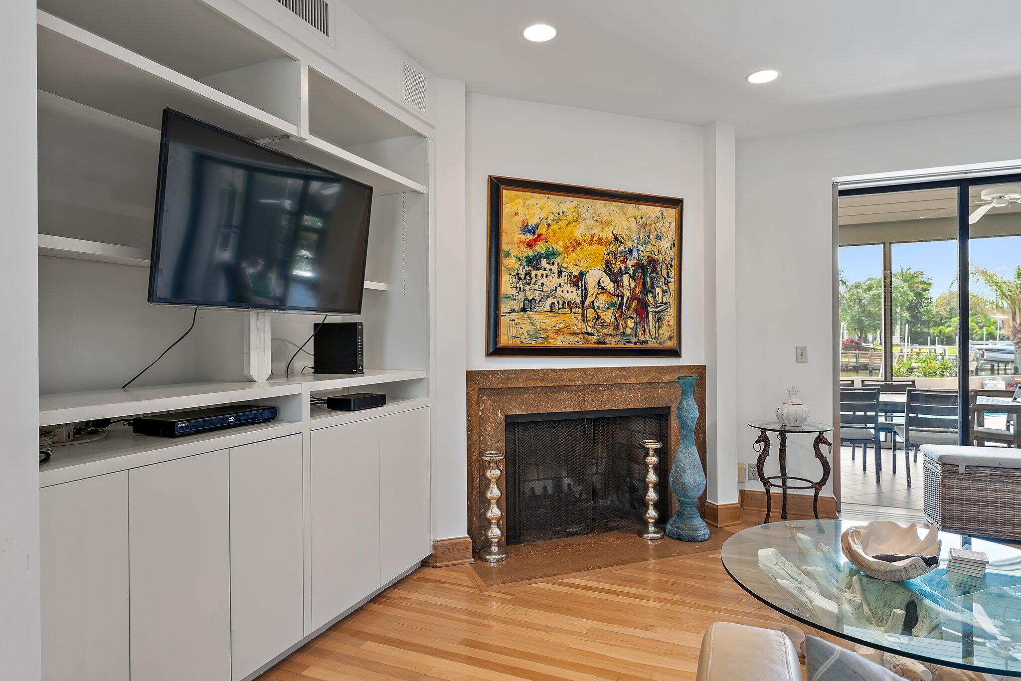 1454 Point Way North Palm Beach, FL 33408 - Photo 18 of 47 a living room with furniture a flat screen tv and a fireplace