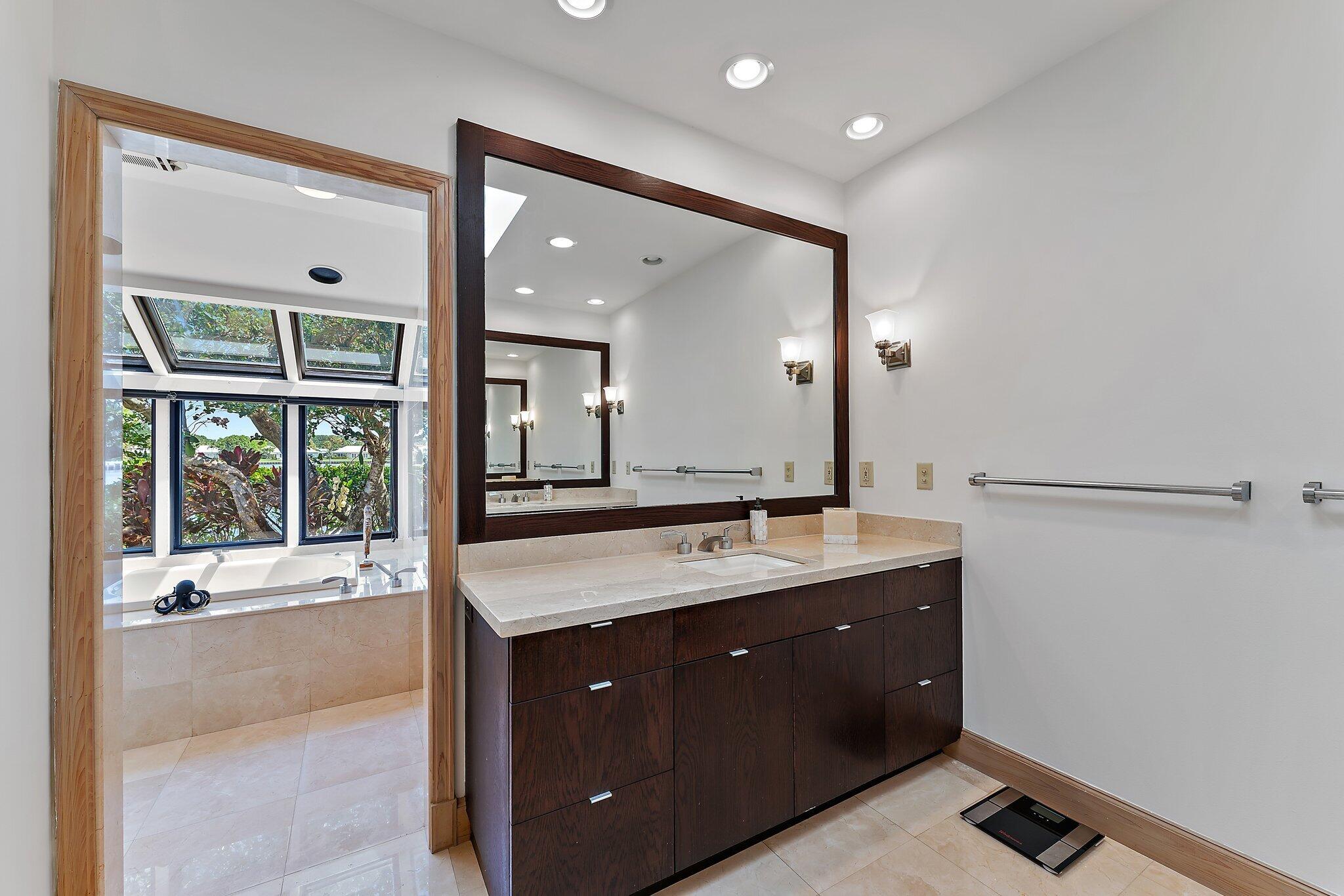 1454 Point Way North Palm Beach, FL 33408 - Photo 21 of 47 a spacious bathroom with a granite countertop sink mirror and a bath tub