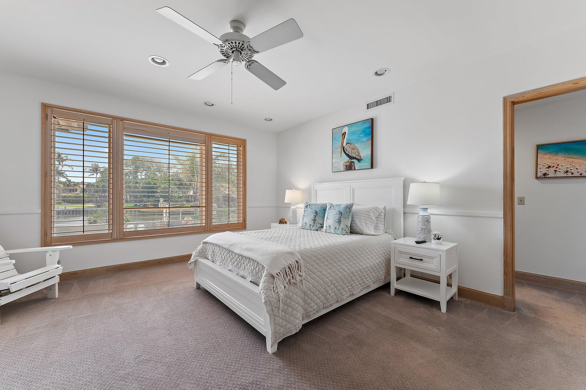 1454 Point Way North Palm Beach, FL 33408 - Photo 26 of 47 a spacious bedroom with a bed and a large window