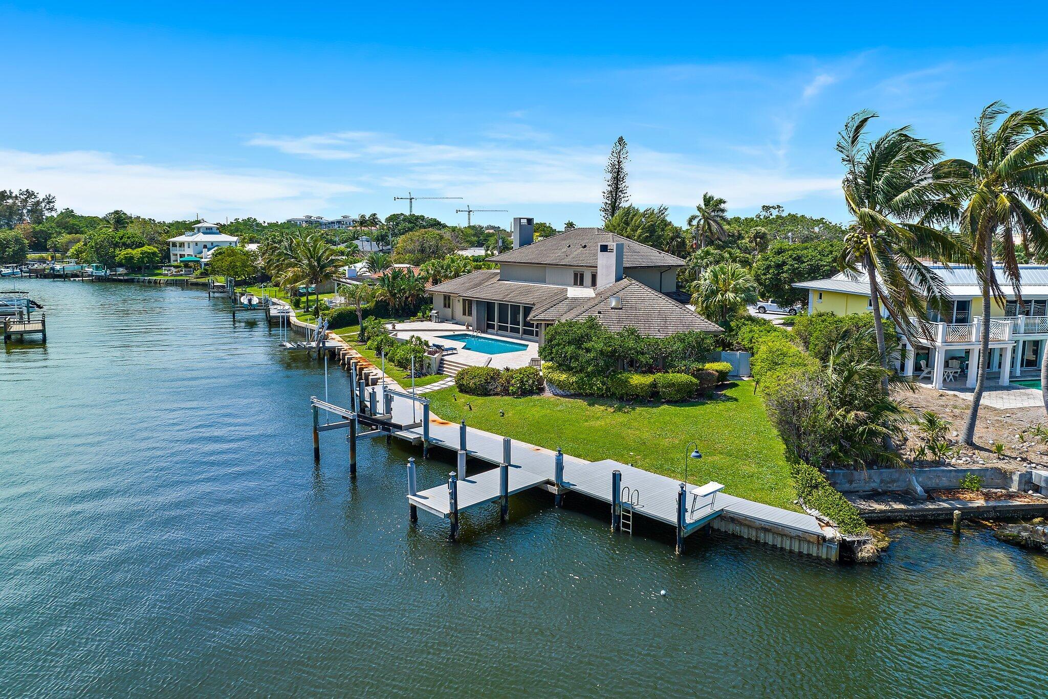 1454 Point Way North Palm Beach, FL 33408 - Photo 36 of 47 a view of a lake with lawn chairs