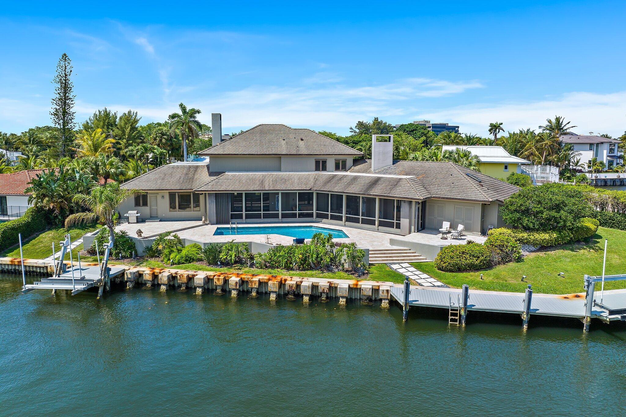 1454 Point Way North Palm Beach, FL 33408 - Photo 37 of 47 a front view of a house with a garden and lake view