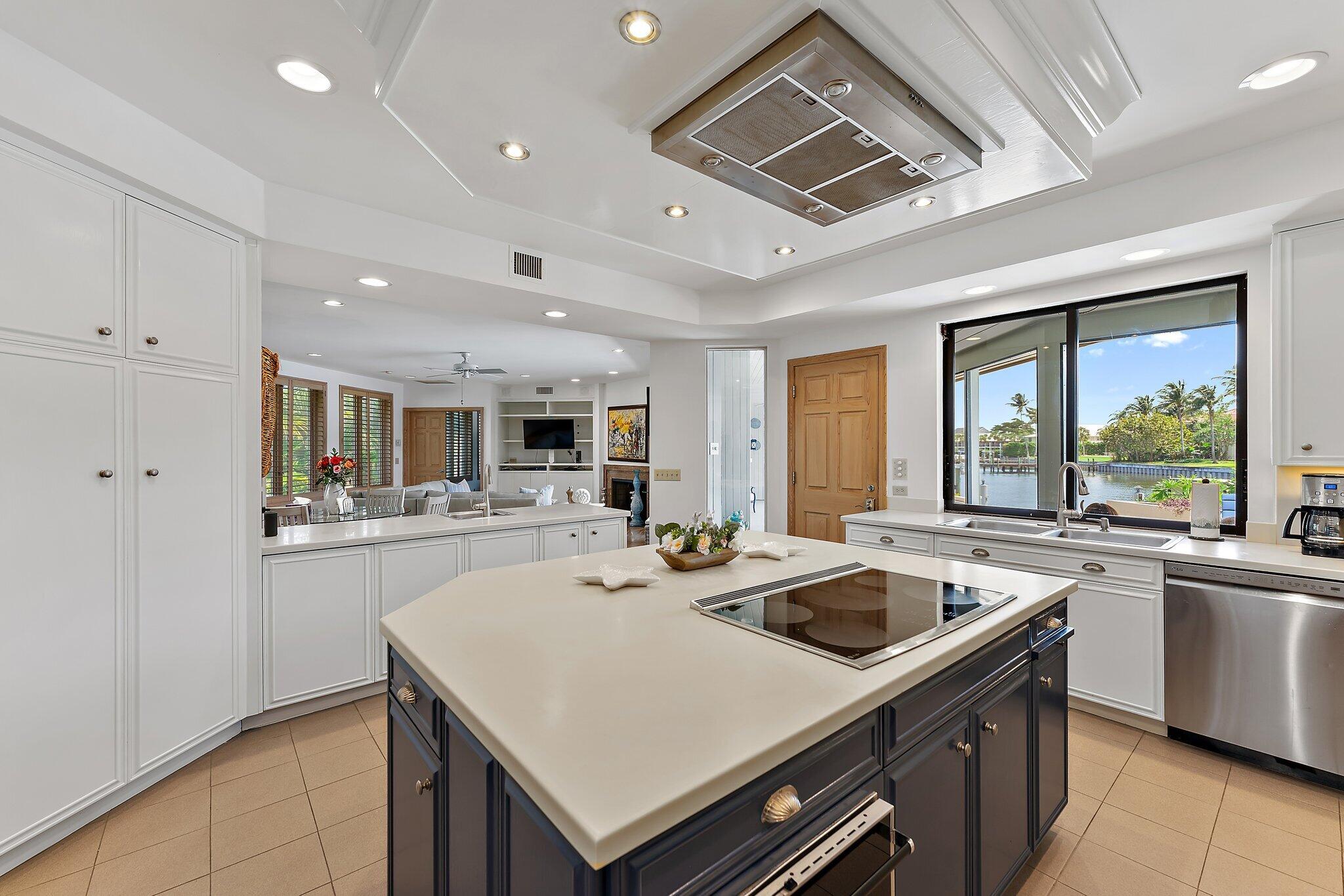 1454 Point Way North Palm Beach, FL 33408 - Photo 10 of 47 a kitchen that has a sink a stove and chairs