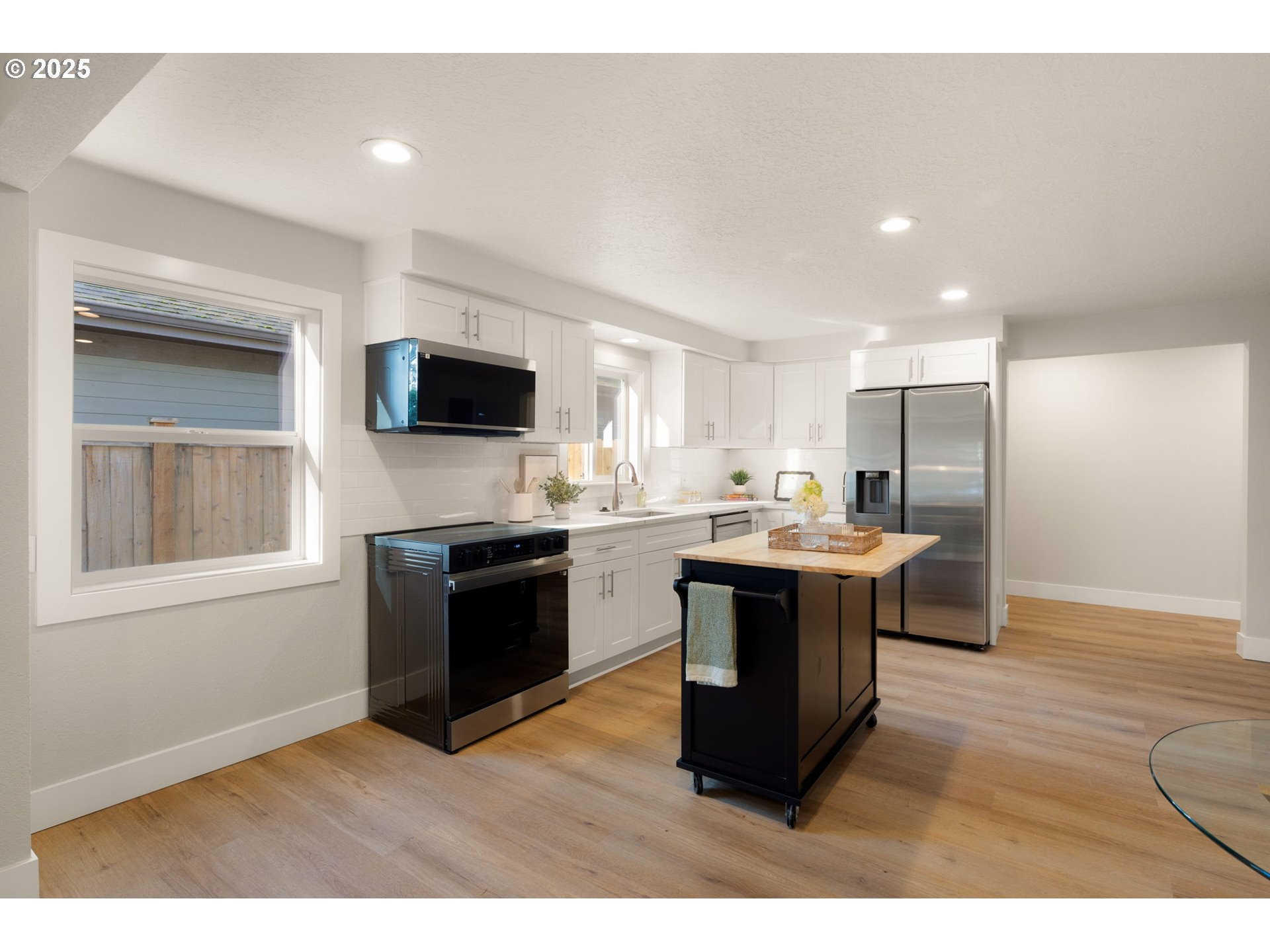1489 Cal Young Road Eugene, OR 97401 - Photo 18 of 47 a kitchen with stainless steel appliances kitchen island granite countertop a stove a sink and a refrigerator