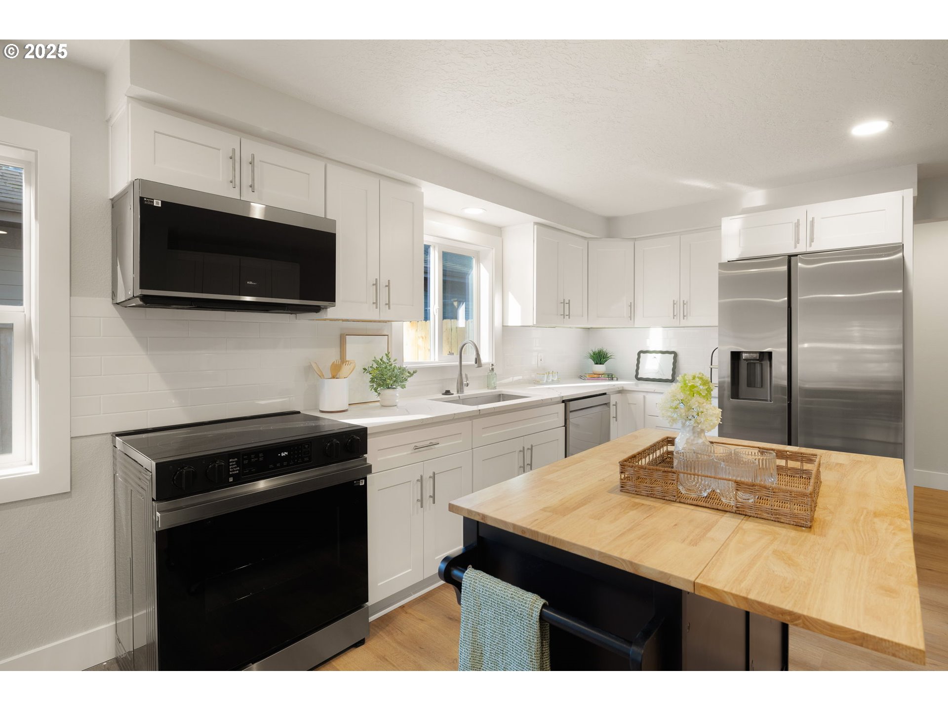 1489 Cal Young Road Eugene, OR 97401 - Photo 19 of 47 a kitchen with kitchen island a sink stainless steel appliances and cabinets