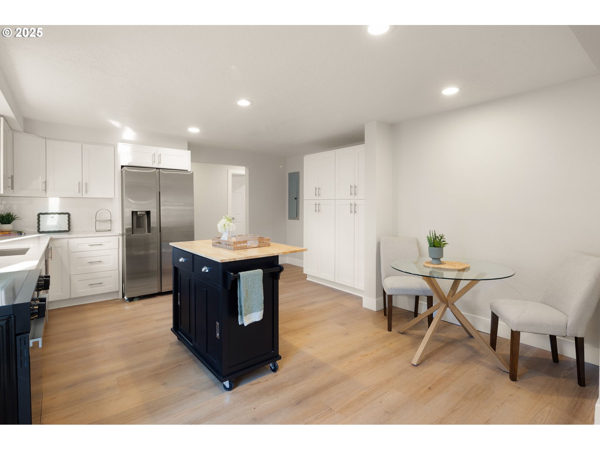 1489 Cal Young Road Eugene, OR 97401 - Photo 20 of 47 a kitchen with stainless steel appliances kitchen island granite countertop a table chairs and a refrigerator