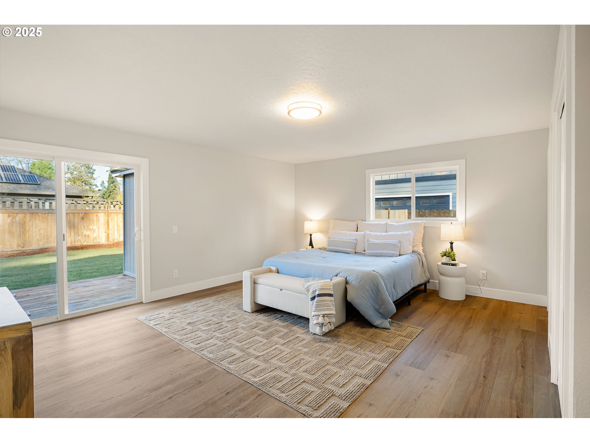 1489 Cal Young Road Eugene, OR 97401 - Photo 29 of 47 a spacious bedroom with a bed and wooden floor