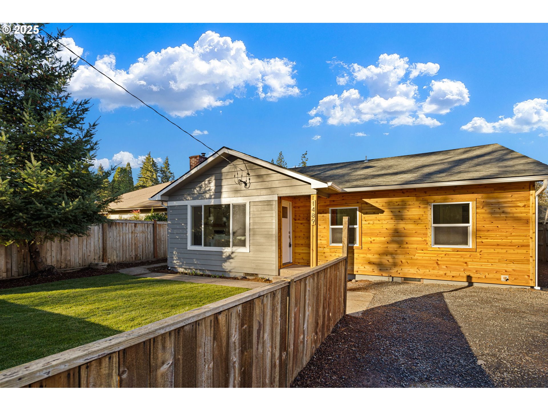 1489 Cal Young Road Eugene, OR 97401 - Photo 3 of 47 a front view of a house with a garden and yard