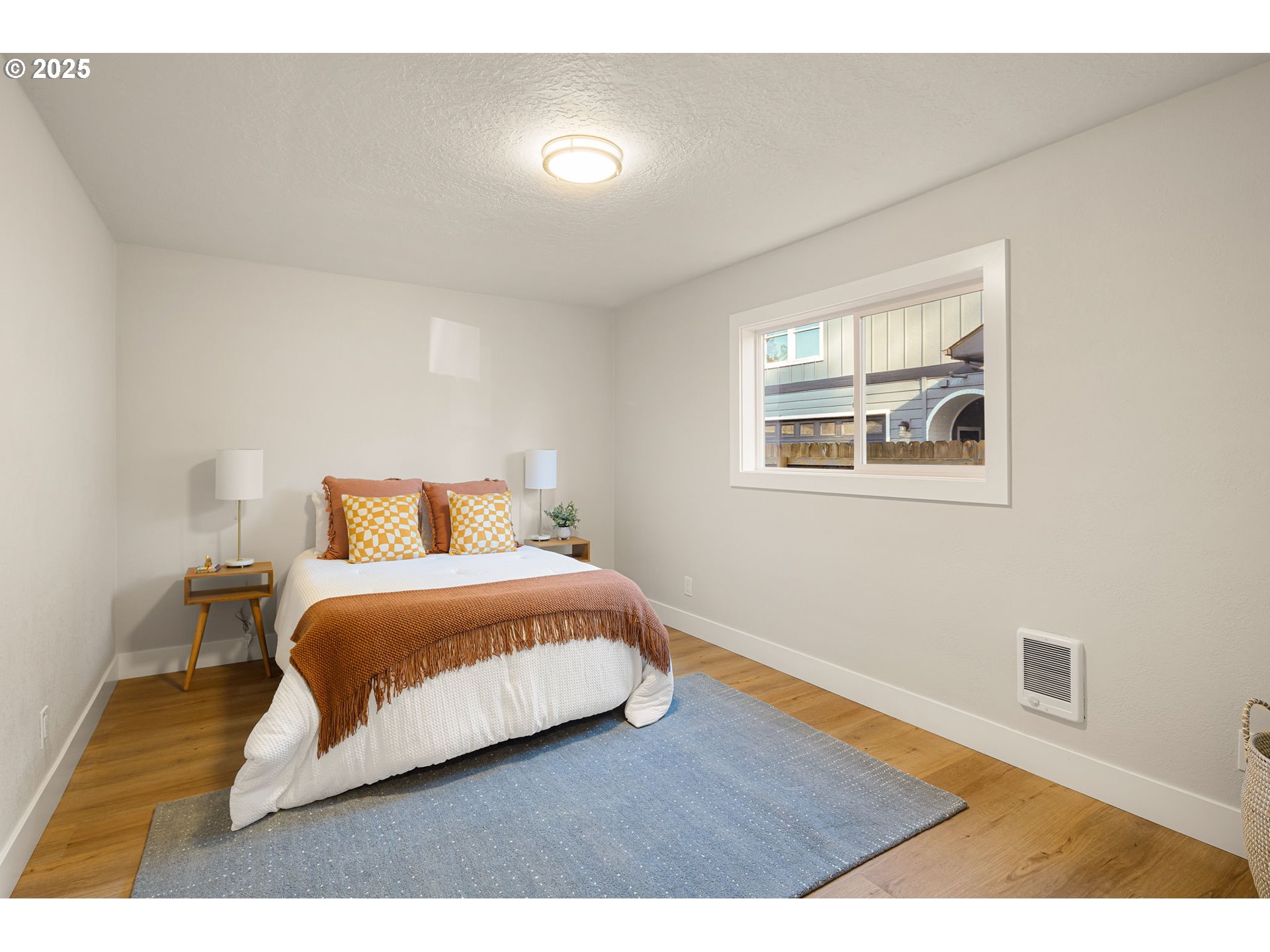 1489 Cal Young Road Eugene, OR 97401 - Photo 39 of 47 a bedroom with a bed lamp on desk and a window