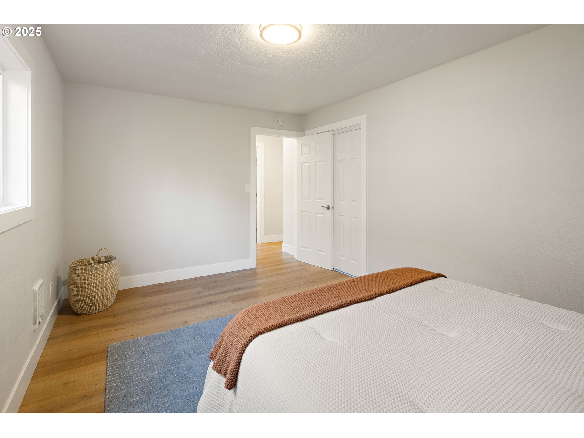 1489 Cal Young Road Eugene, OR 97401 - Photo 40 of 47 a bedroom with a bed and wooden floor