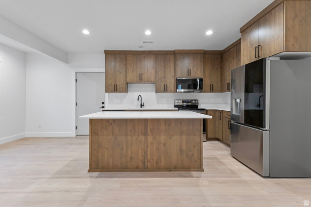 710 East Mountain Road North Ogden, UT 84414 - Photo 25 of 36 Kitchen featuring wood-finish cabinetry and a central island