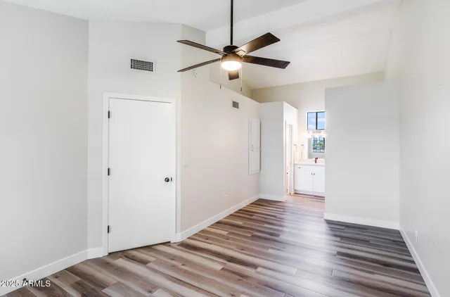 a view of a room with wooden floor