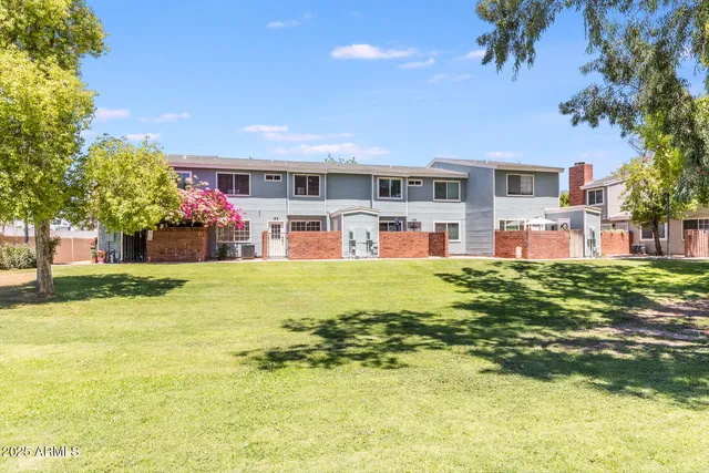 a front view of a building with a garden