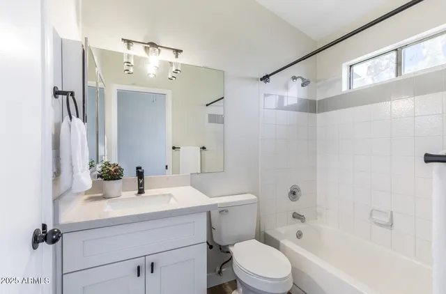 a bathroom with a sink toilet tub and shower