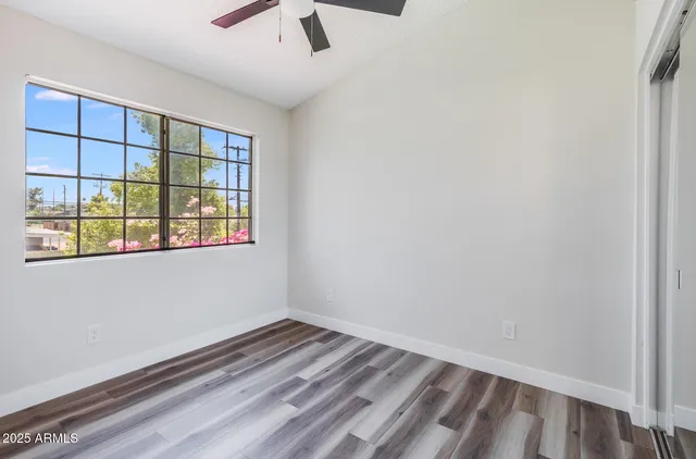 wooden floor in an empty room with a window
