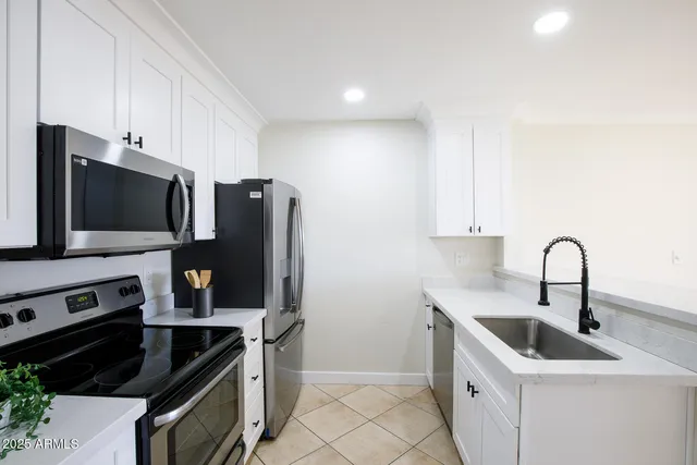 a kitchen with stainless steel appliances granite countertop a sink and a stove