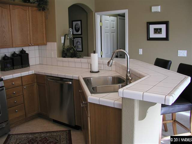 10585 Arbor Way Reno, NV 89521 - Photo 4 of 13 a kitchen with a sink and cabinets