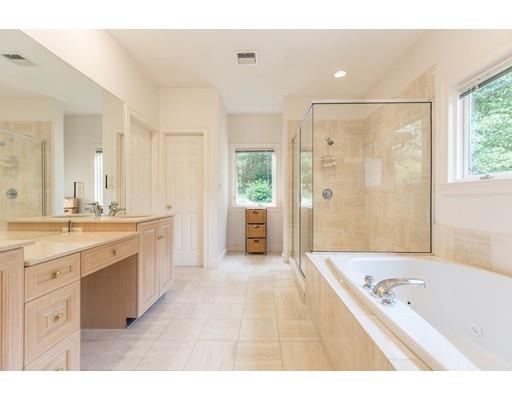 101 Hundreds Road Wellesley, MA 02481 - Photo 12 of 29 a bathroom with a tub a double vanity sink and mirror