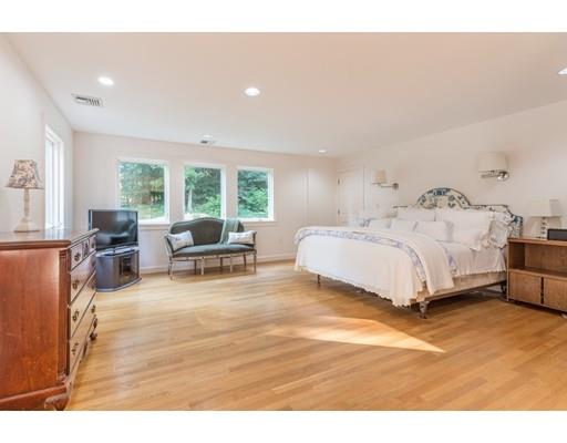101 Hundreds Road Wellesley, MA 02481 - Photo 10 of 29 a spacious bedroom with a bed and large windows
