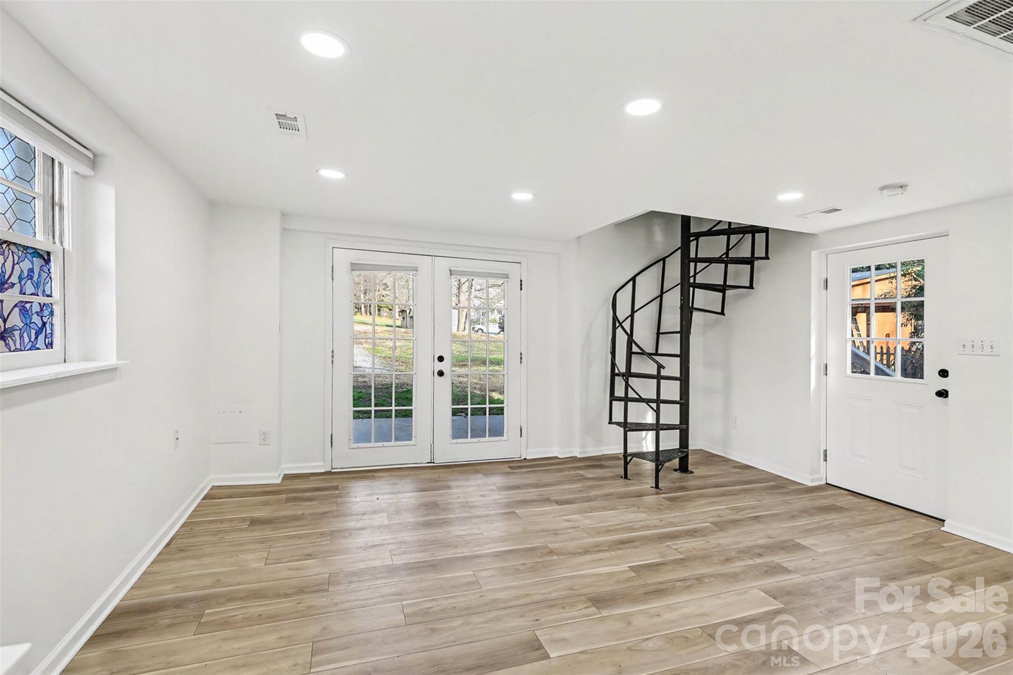 655 Ridgecrest Drive Mooresville, NC 28115 - Photo 14 of 16 a view of an empty room with window and wooden floor