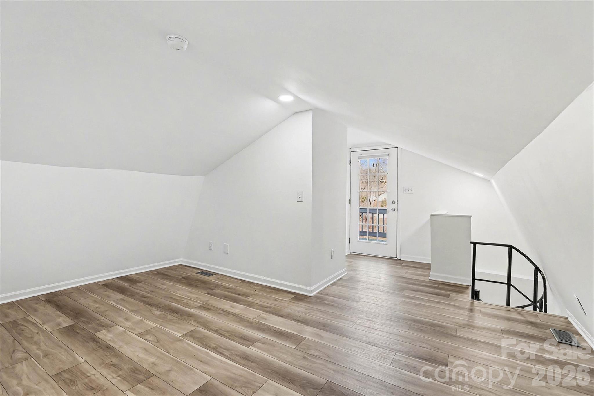 655 Ridgecrest Drive Mooresville, NC 28115 - Photo 7 of 16 a view of an empty room with wooden floor and a window