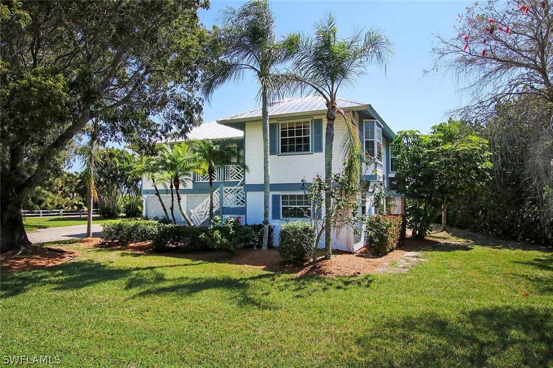 1573 Sand Castle Road Sanibel, FL 33957 - Photo 1 of 31 a view of a house with backyard and sitting area