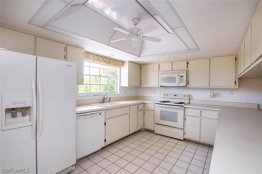 1573 Sand Castle Road Sanibel, FL 33957 - Photo 22 of 31 a kitchen with a sink window and cabinets