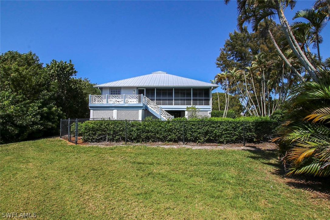 1573 Sand Castle Road Sanibel, FL 33957 - Photo 30 of 31 a front view of a house with a yard