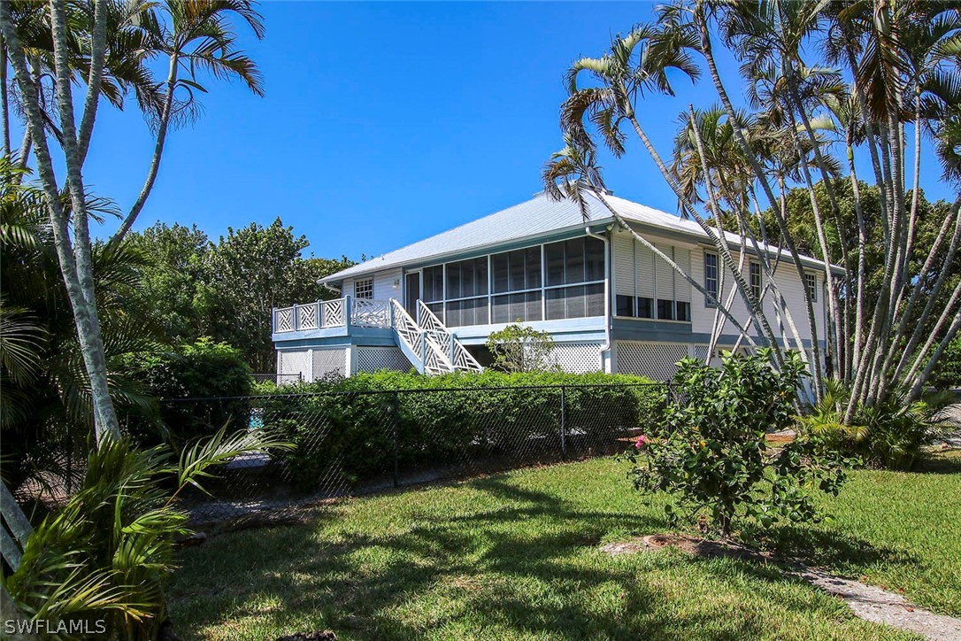 1573 Sand Castle Road Sanibel, FL 33957 - Photo 31 of 31 a front view of a house with garden
