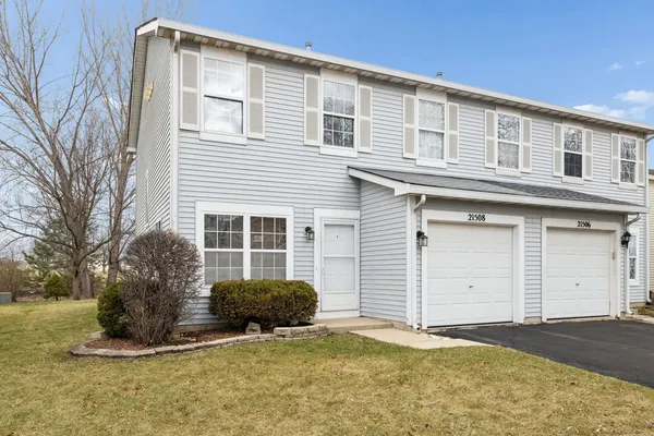 a view of a house with a yard and garage