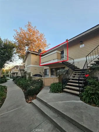 a front view of a house with a yard and outdoor seating