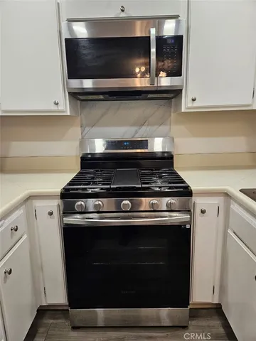 a stove top oven sitting inside of a kitchen