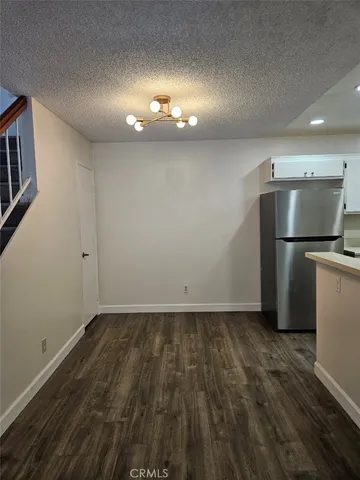 a view of staircase with wooden floor and fan