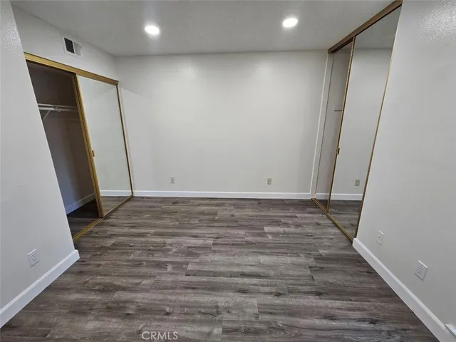 a view of hallway with wooden floor