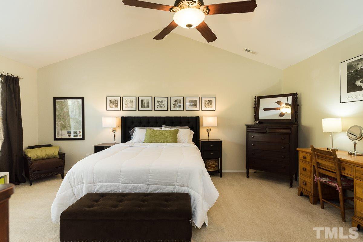 8516 Slabstone Court Raleigh, NC 27613 - Photo 14 of 30 a bedroom with a bed and dresser
