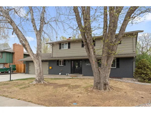 a house that has a tree in front of the house