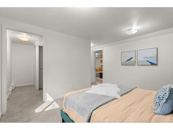 a bedroom with a bed and a painting on the wall