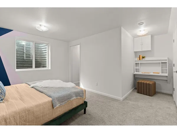 a bedroom with a bed and a sink