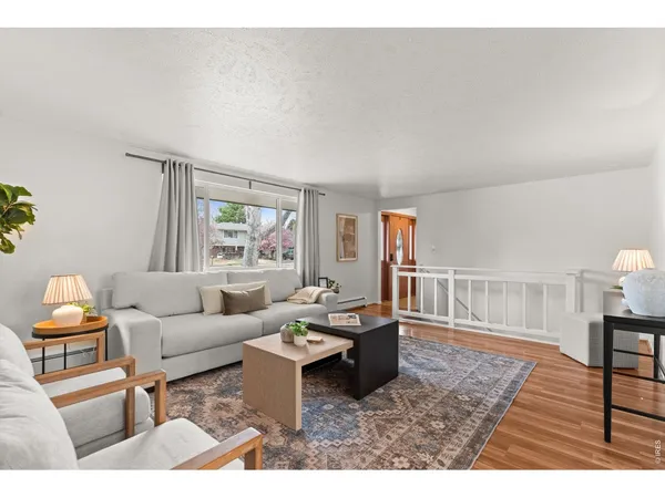 a living room with furniture a rug and a chandelier