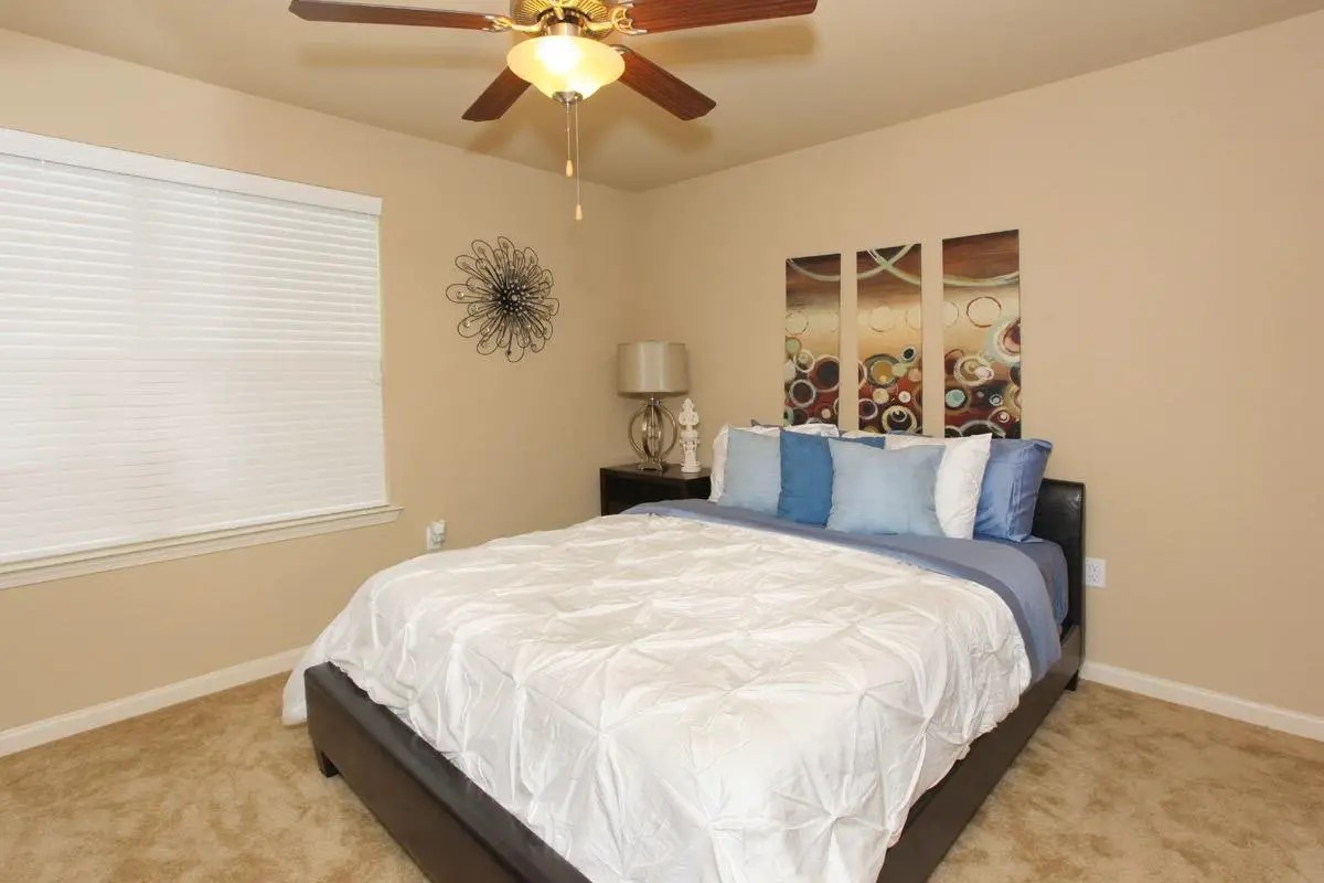 11320 Greenwell Springs Road Baton Rouge, LA 70814 - Photo 17 of 19 a bedroom with a bed and a chandelier