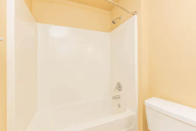 a bathroom with a bathtub and a toilet