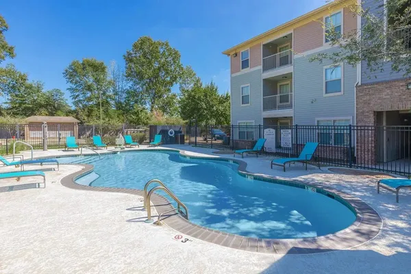 a swimming pool with outdoor seating and yard