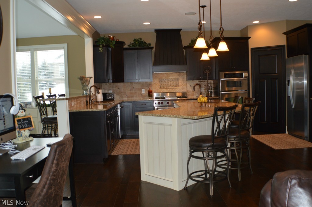 5785 Spring Ridge Drive Medina, OH 44256 - Photo 7 of 25 Kitchen opens to the morning room with wall of windows and spectacular view, woods at the backside of the property. The light airy feel of the morning room, enjoyable all year round.